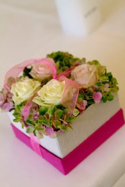 Bloemdoos met witte en roze rozen en een fuchsia lint